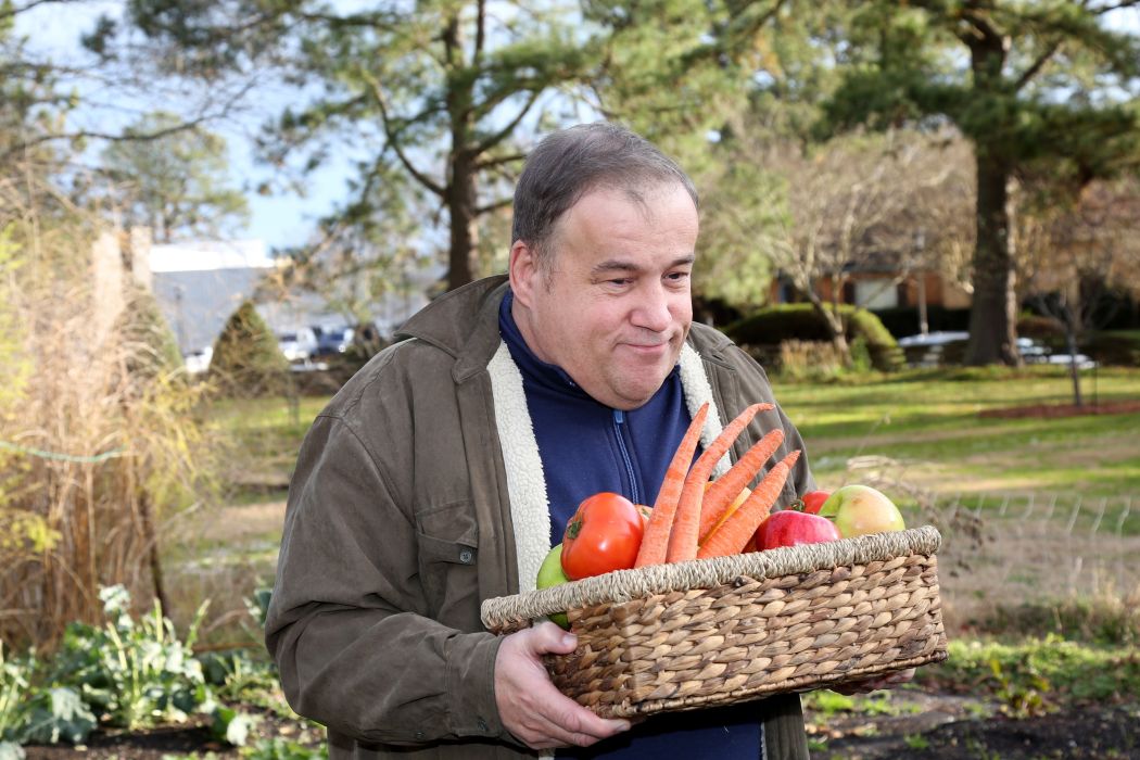Autistic,Man,Working,In,The,Garden,Holding,Basket,Full,Of