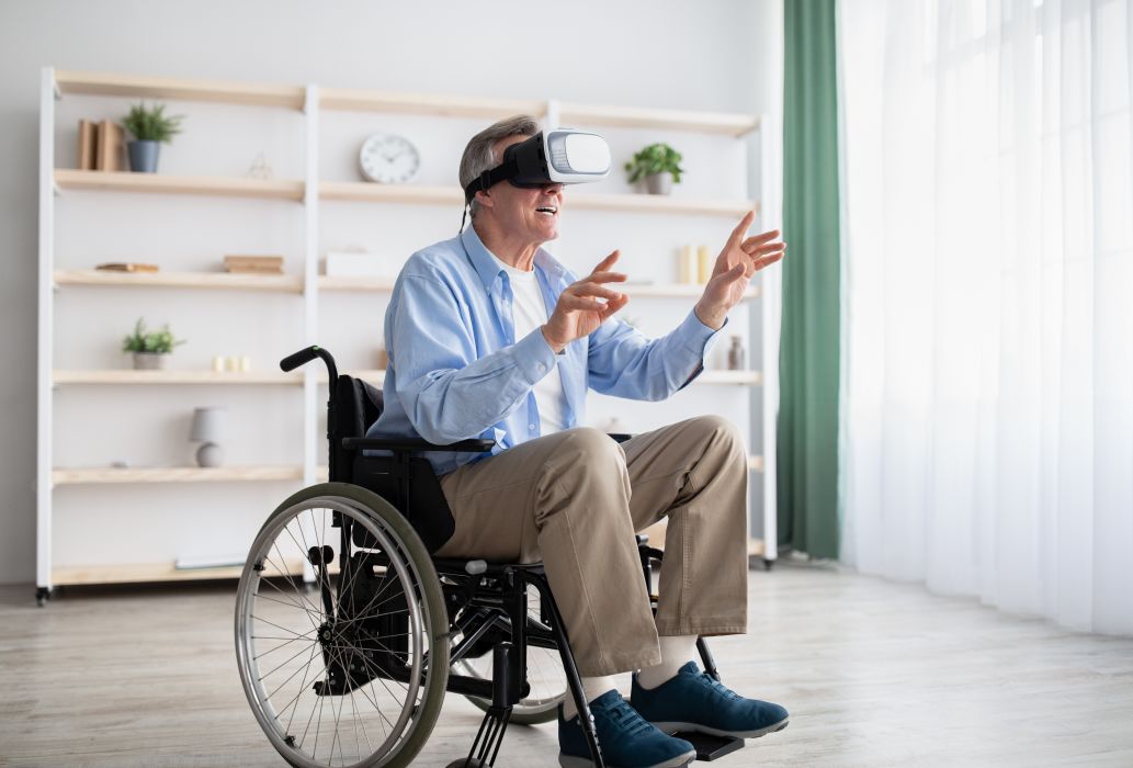Happy,Handicapped,Senior,Man,In,Wheelchair,Using,Vr,Headset,To